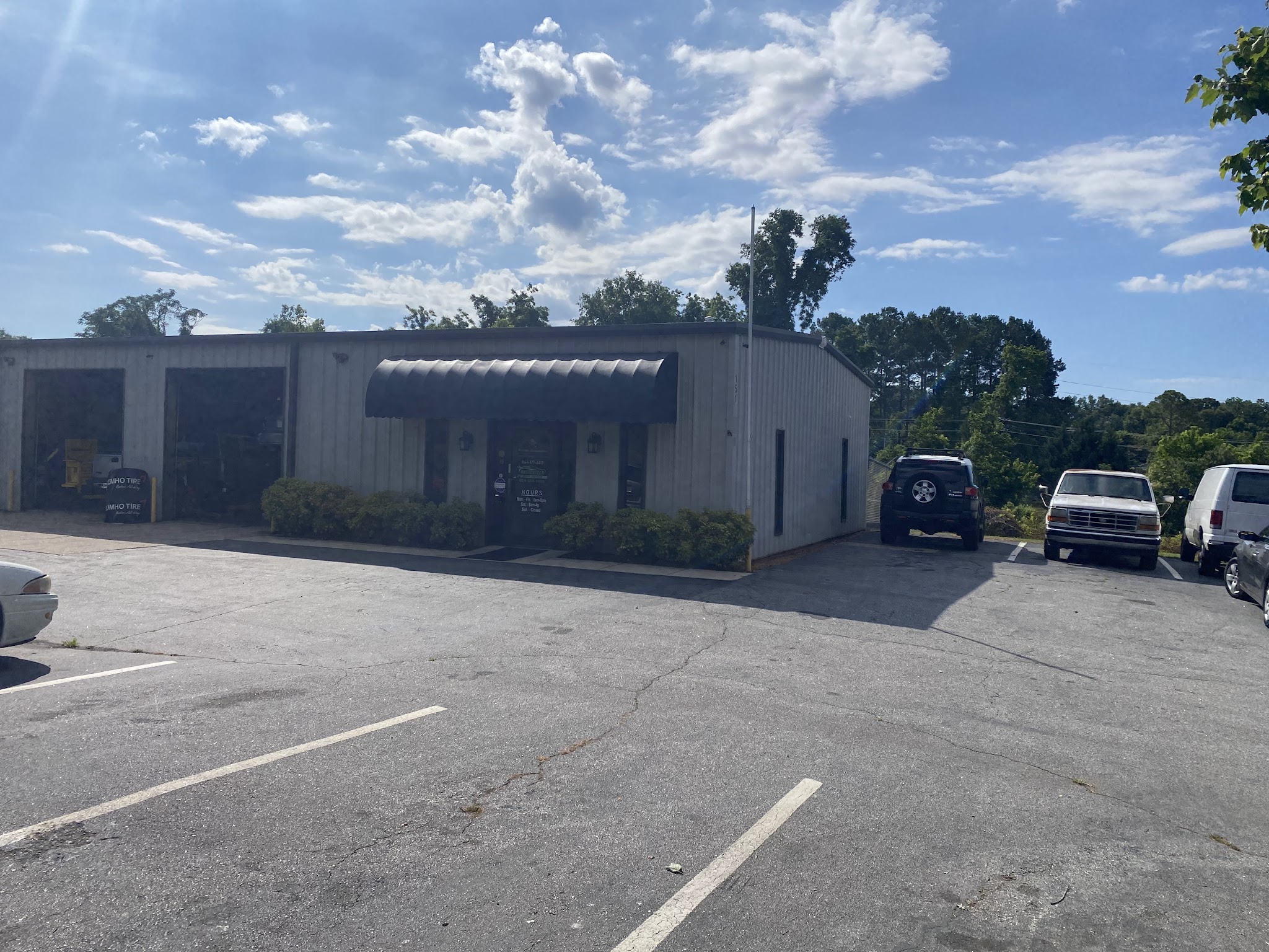 The shop building and parking lot at 151 S Forest St